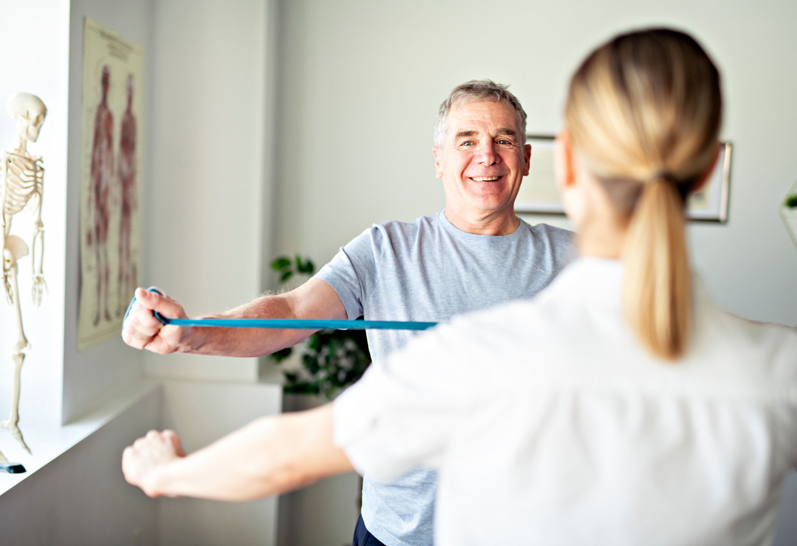 A Modern rehabilitation physiotherapy worker with senior client